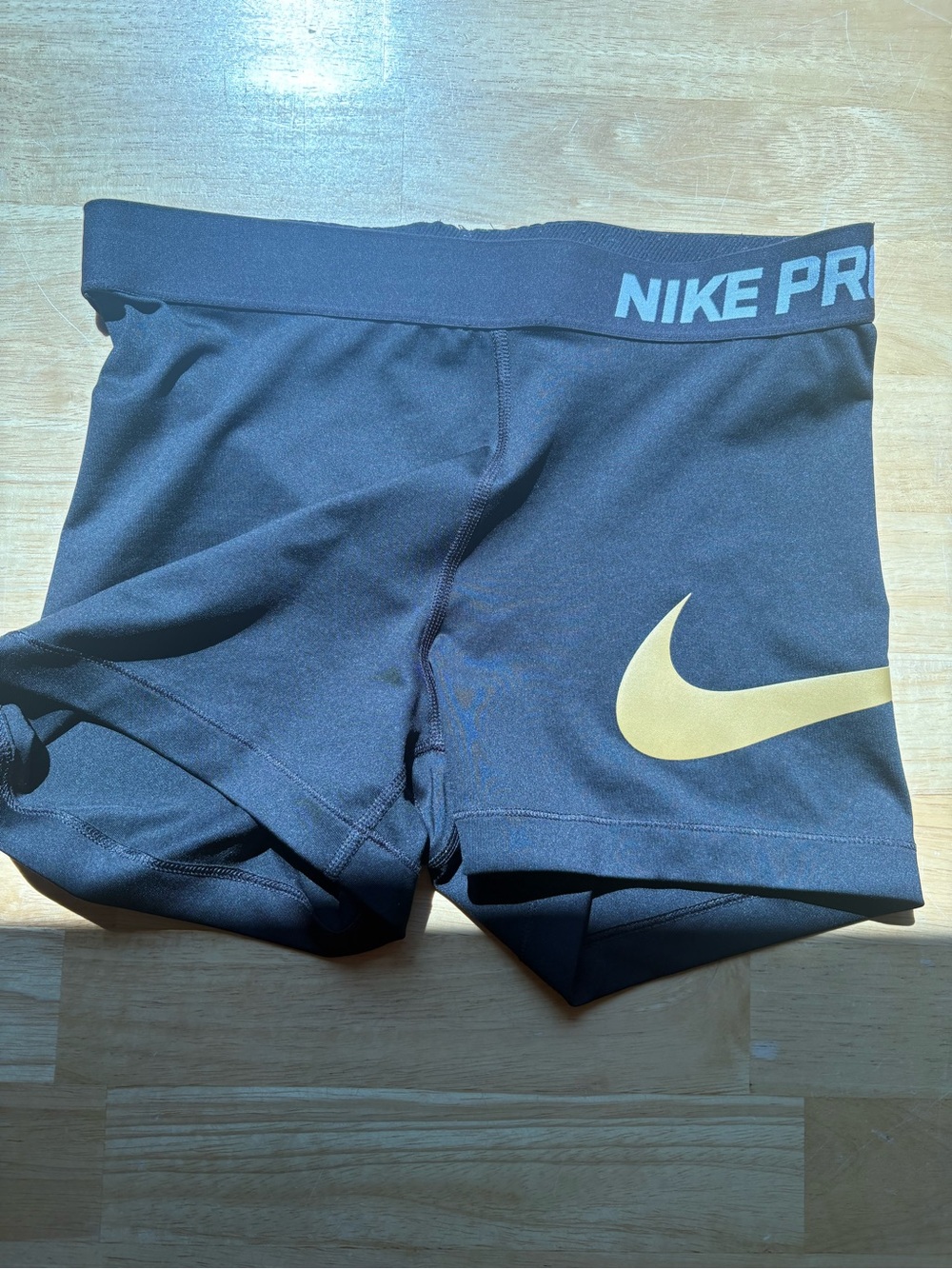 Nike Black Compression Shorts with Gold Swoosh